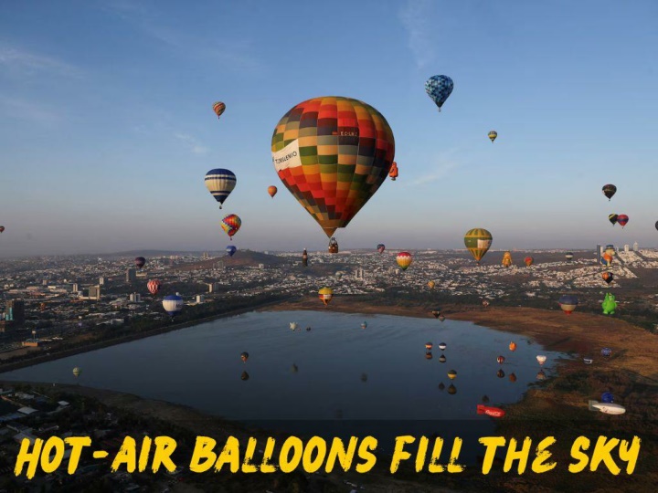 hot air balloons fill the sky