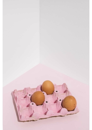 three-brown-eggs-pink-rack-table